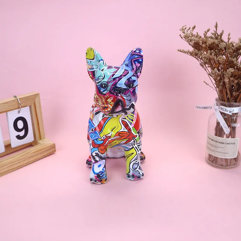 Graffiti coloured solid resin French bulldog statue on a wooden surface.
