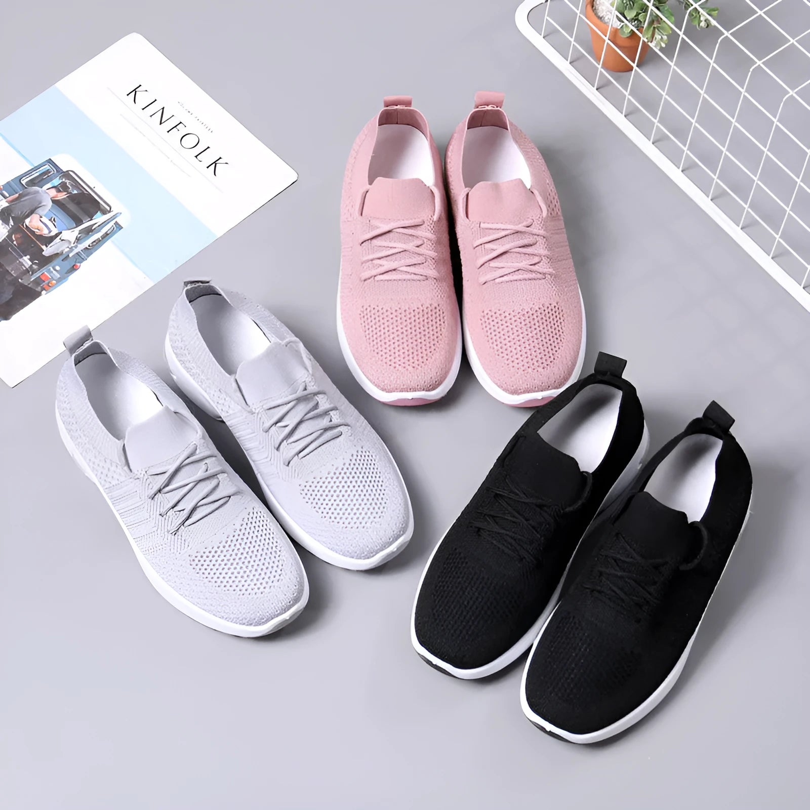 Women's solid-colour mesh sneaker with lace-up front and round toe, shown in grey.