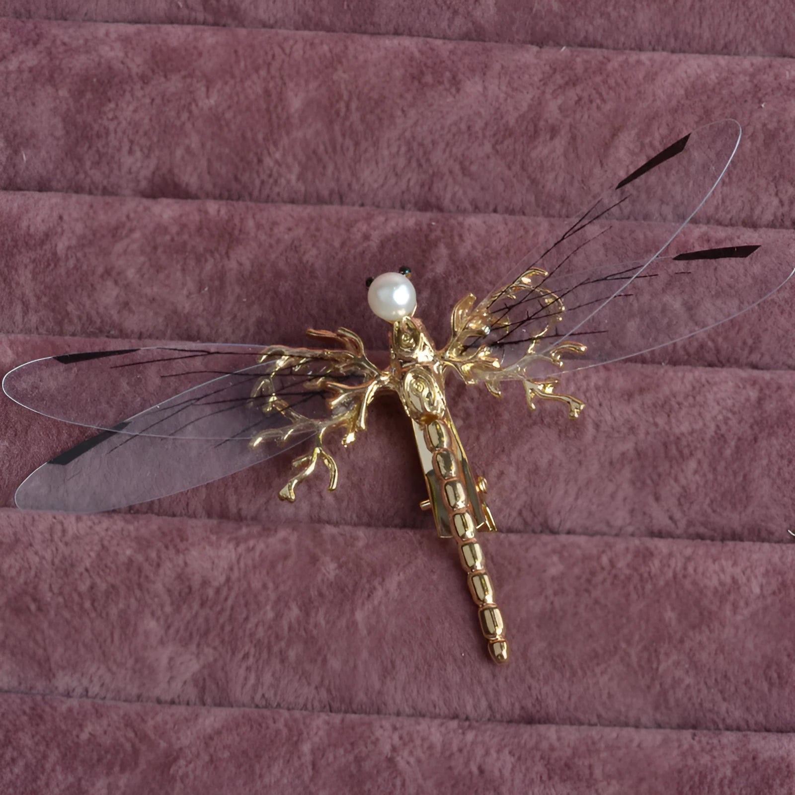 Golden dragonfly-shaped women's headdress with side clip on white background