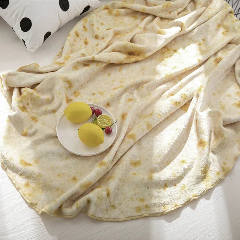 Round coral coloured flannel burrito blanket with a delicious print, shown folded.