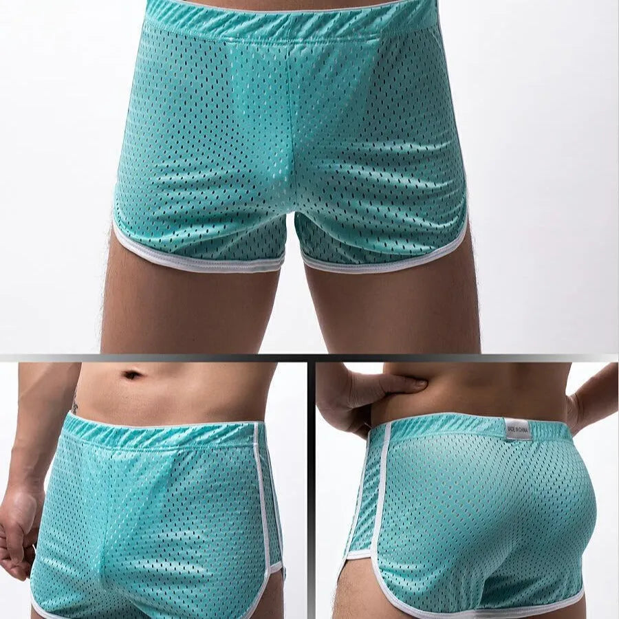 Men's grey cotton blend three-point boxer shorts laid flat, showing mid-waist design and knitted fabric texture.