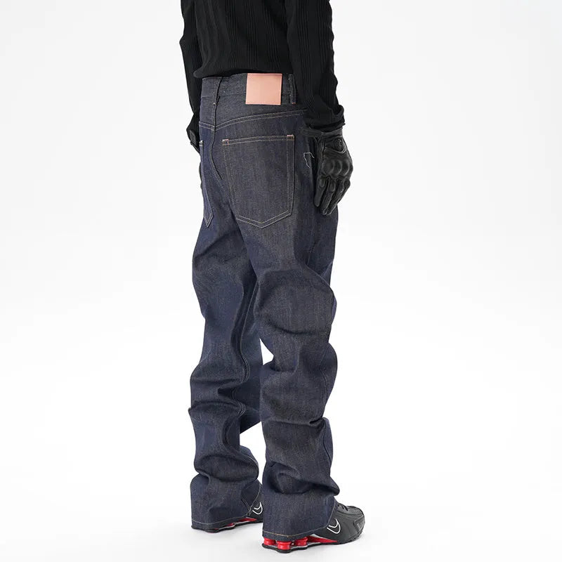 Man wearing dark blue loose fit straight leg denim jeans.