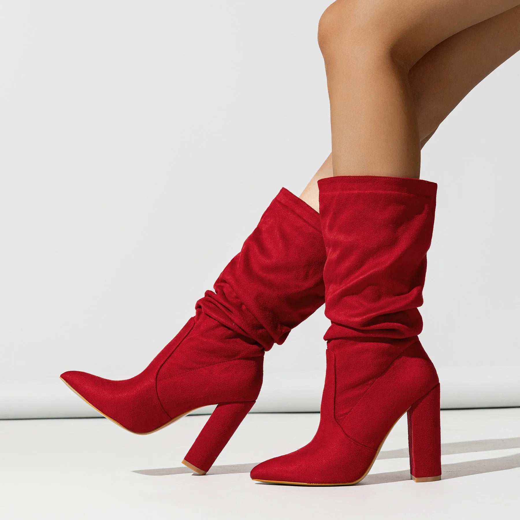 Black suede women's boots with a chunky high heel and pointed toe.