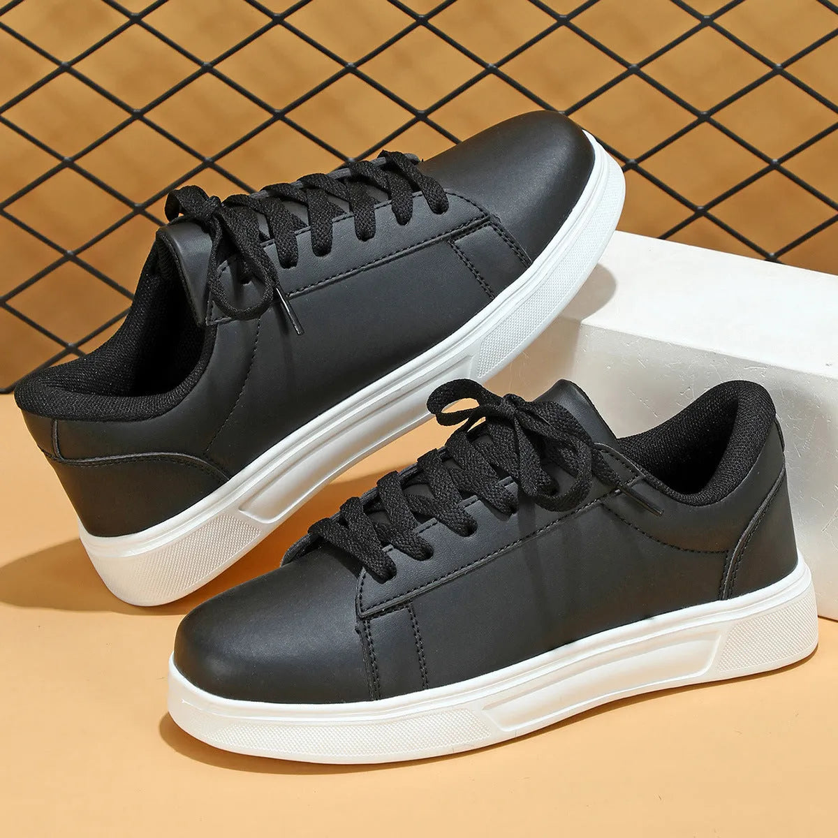 Platform skateboard casual sneaker in beige brown with low top, round toe, and a cross strap detail.