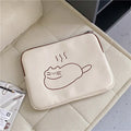 Embroidered cat design on a navy blue nylon tablet protective sleeve with a black zipper, shown next to a tablet.