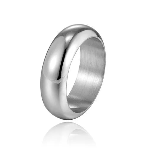 Glossy electroplated titanium steel ring in gold, black and steel colours showing metallic finish