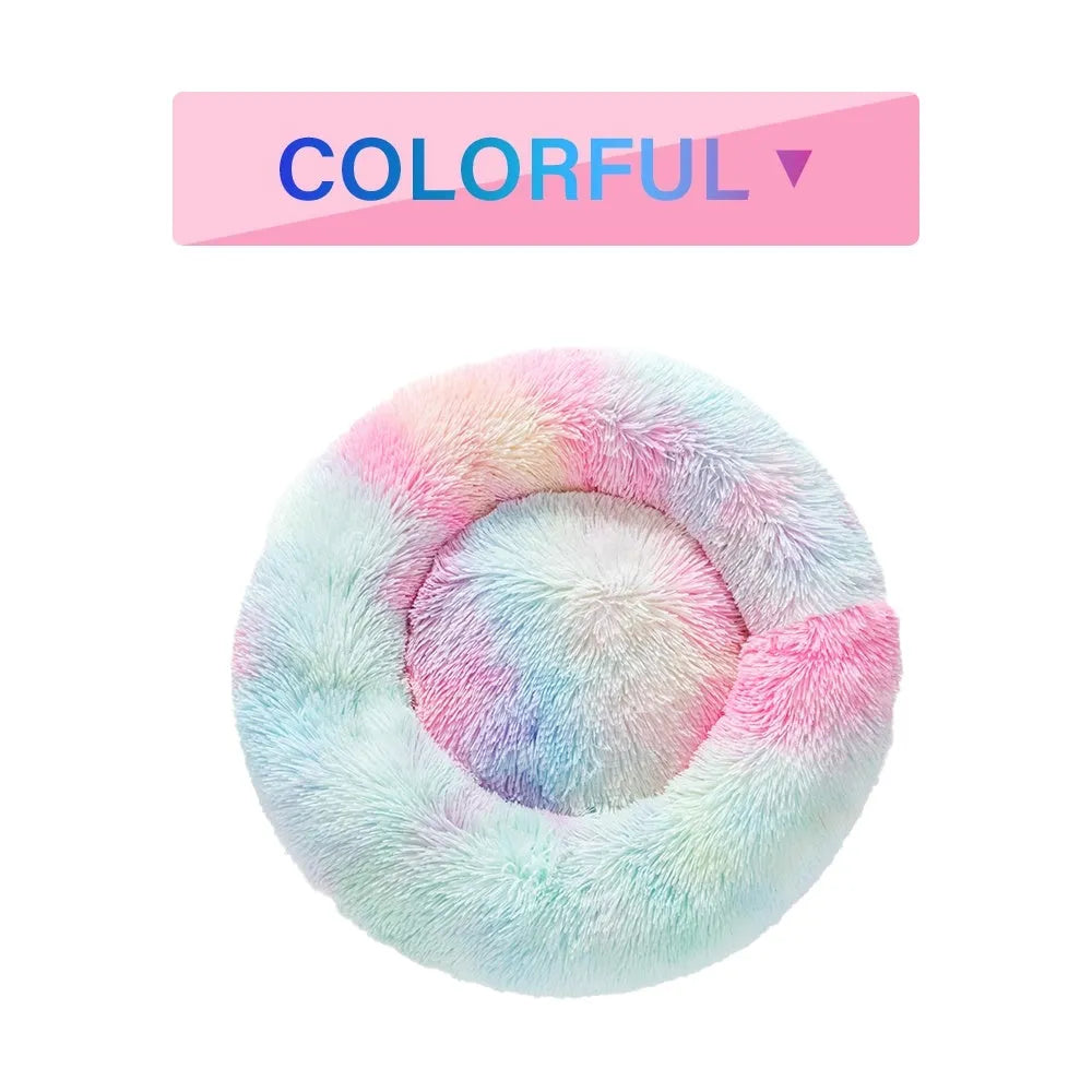 Fluffy grey donut-shaped dog bed with high plush sides on a wooden floor.