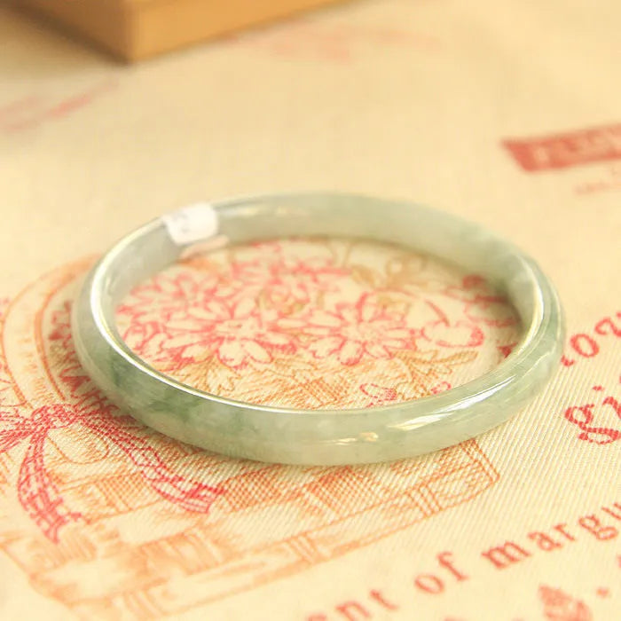 Green jade geometric bracelet with waxy finish showing 10mm width and Chinese style design