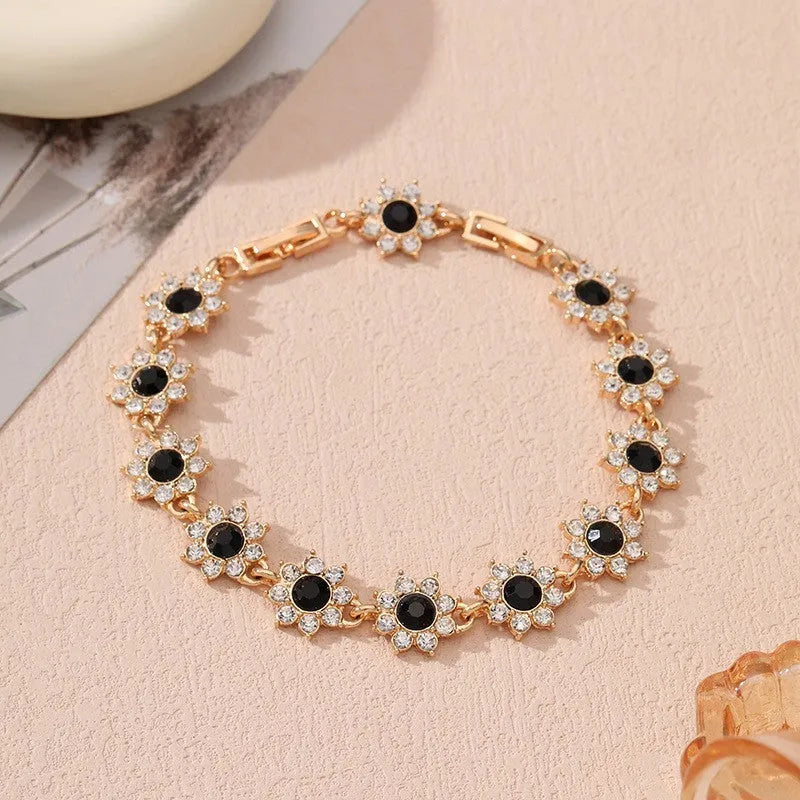Floral zinc alloy bracelet in electroplated gold and silver colour variants with crystal and diamond effects