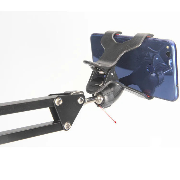 Black universal phone stand with long adjustable metal arm and heavy round base on a desk