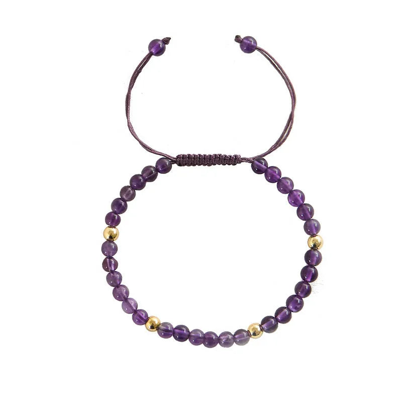 Handmade purple amethyst and 14K gold bracelet with 4mm round beads on a wrist.