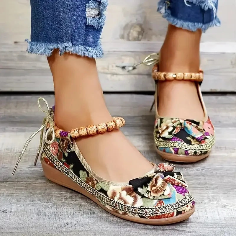 Women's black ethnic platform sandals with elastic band and cloth upper on a plus-size foot.