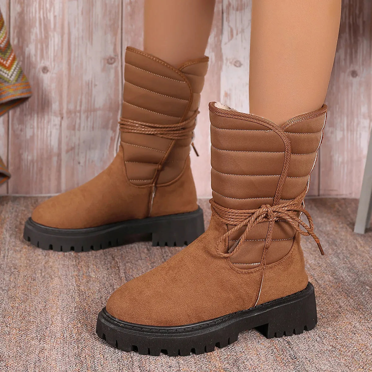 Women's black chunky heel snow boots with lace-up design and fleece lining on a high-top suede upper.
