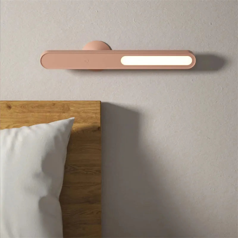 White geometric desk lamp with magnetic base mounted on a metal wall surface.