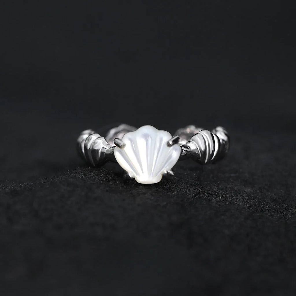 Adjustable silver ring with natural white shell and tiger eye detail, shown in white gold and 18K gold electroplated finishes.