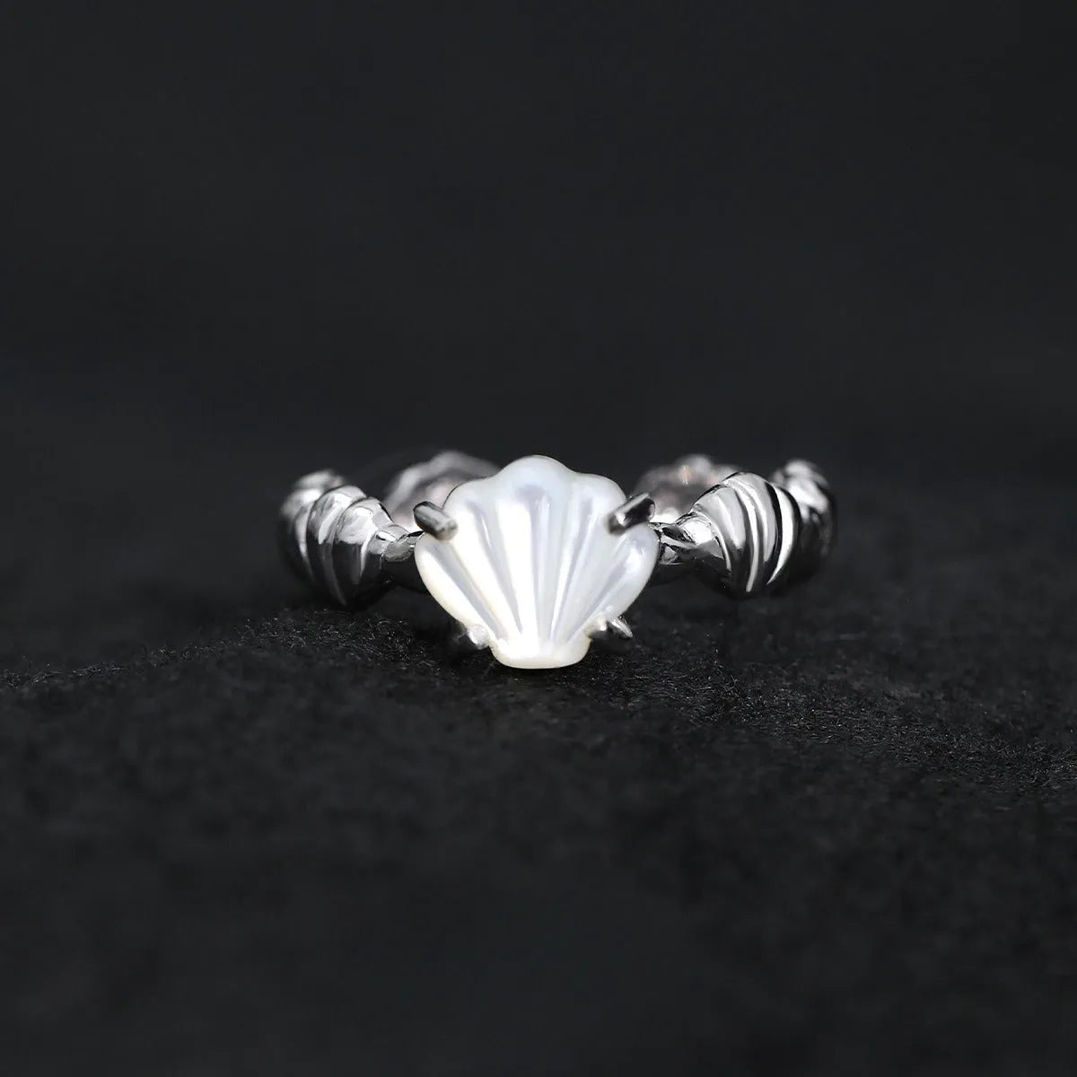 Adjustable silver ring with natural white shell and tiger eye detail, shown in white gold and 18K gold electroplated finishes.