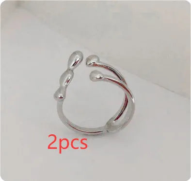 Brass spherical ring for women in gold or silver colour on a circular band.