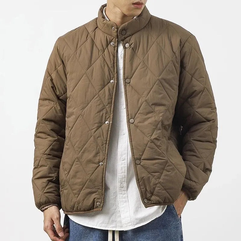 Men's black diamond lattice quilted winter jacket with a loose, longline fit on a hanger.