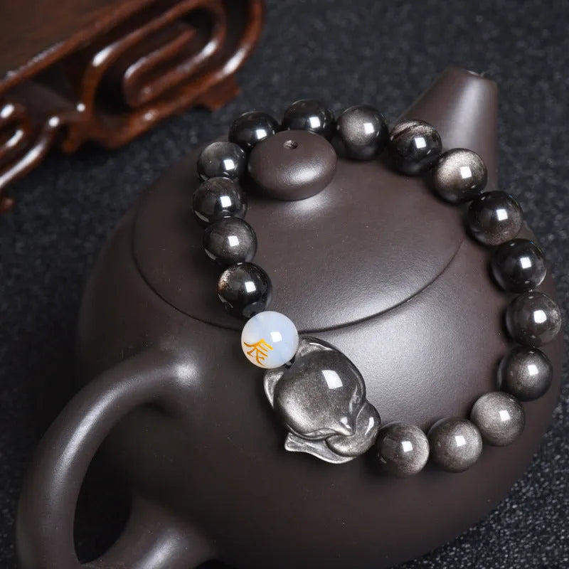 Natural obsidian bracelet with zodiac charm in gold, silver, or black stone styles.