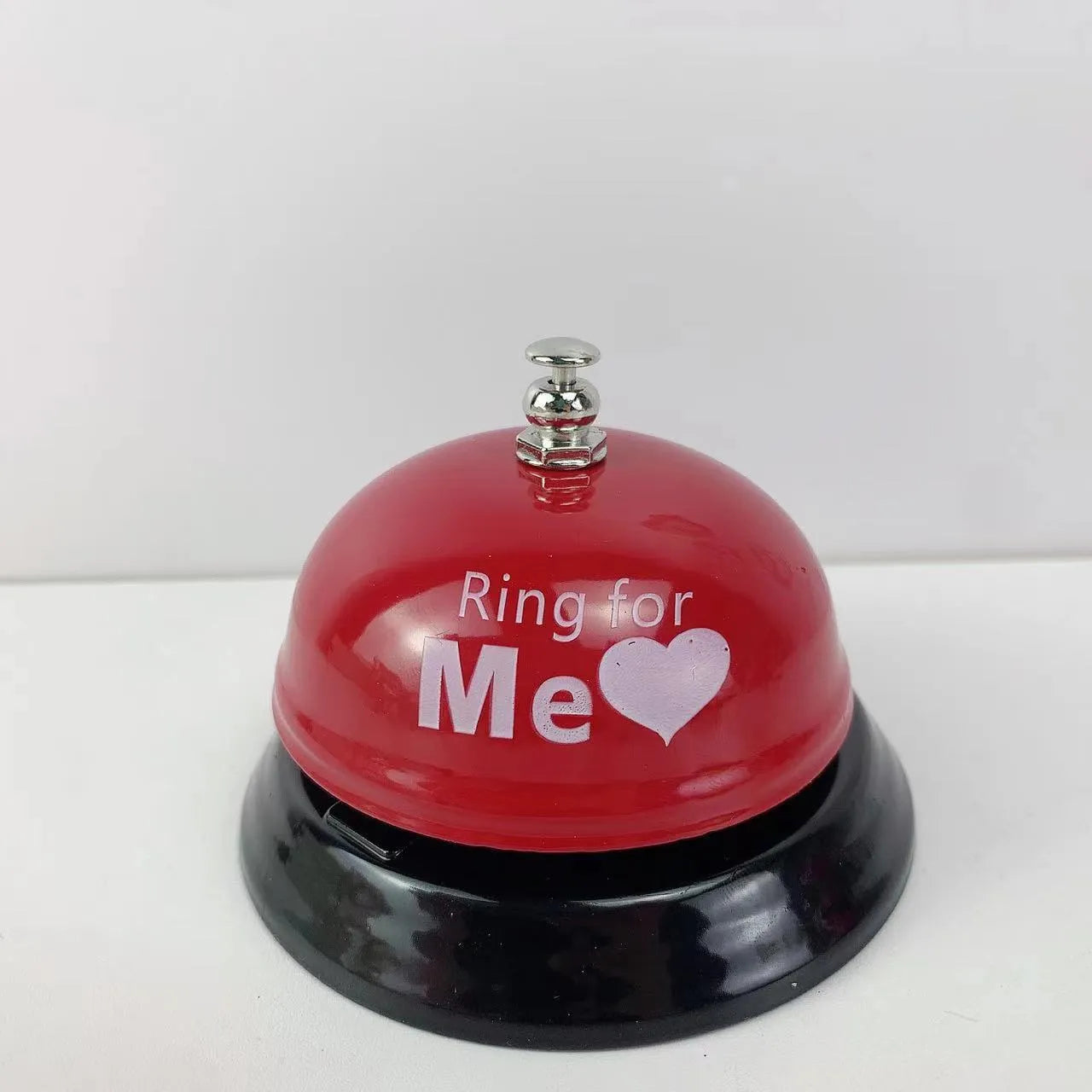 Iron game bell in assorted colours including red, blue, green, pink, and yellow for service or classroom use.