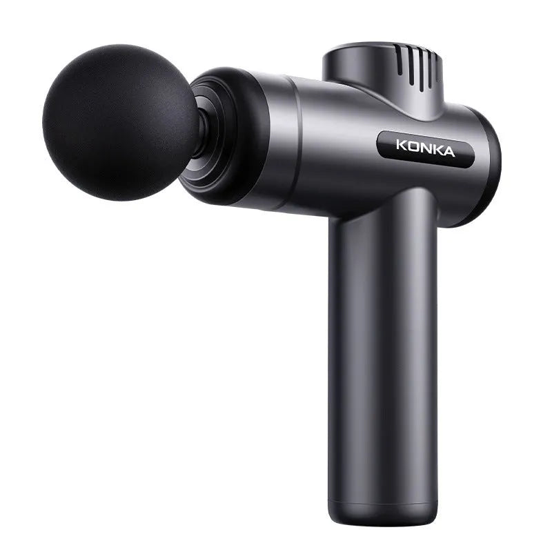 Konka V19 grey massage gun with multiple silicone attachment heads on a table.