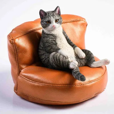 Lazy cat car ornament figure on fabric sofa, 7.5cm high resin model decoration.