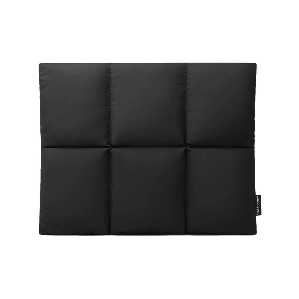 Soft black retro-style laptop sleeve for 13 to 15.6 inch laptops on a table.