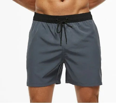 Men's blue fitness shorts with a drawstring waistband and a side zipper pocket.