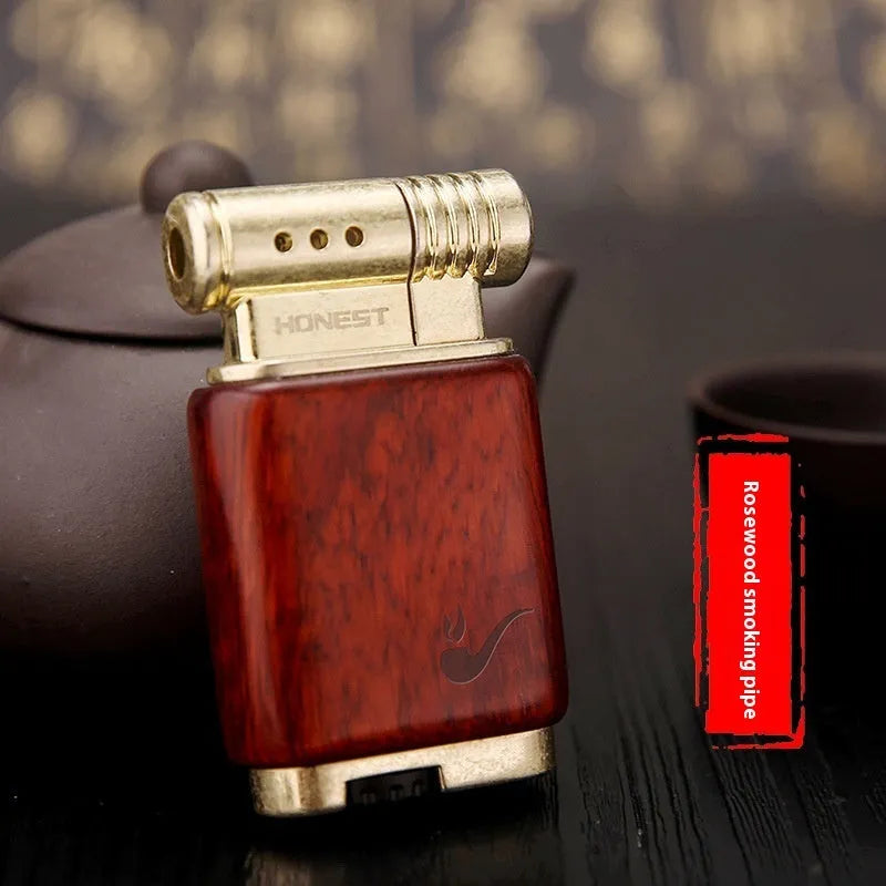 A decorative gas lighter with a carved wooden handle combining black wood, rosewood symbols, and a red wood tube accent.