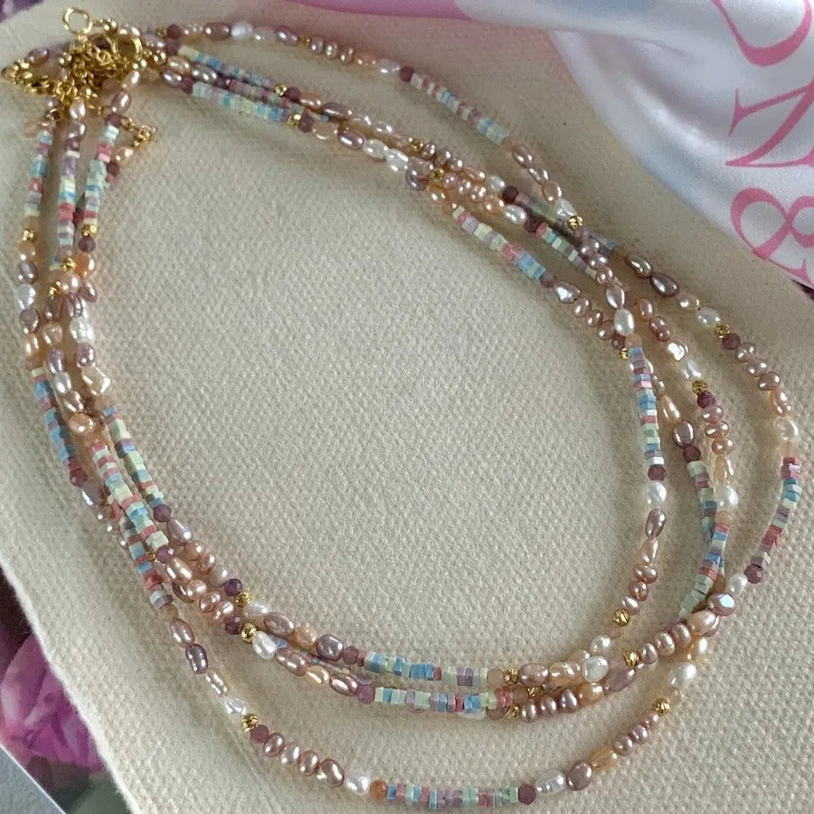A women's bracelet and necklace set with irregular natural pearls and a 14K gilded purple finish.