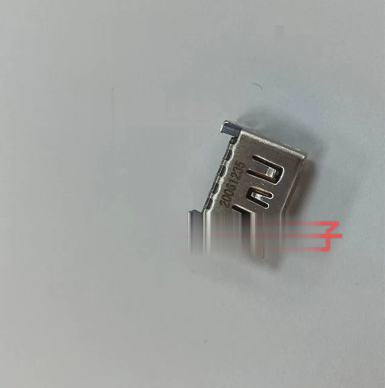 Silver coloured HDMI host socket interface for gaming console accessory.