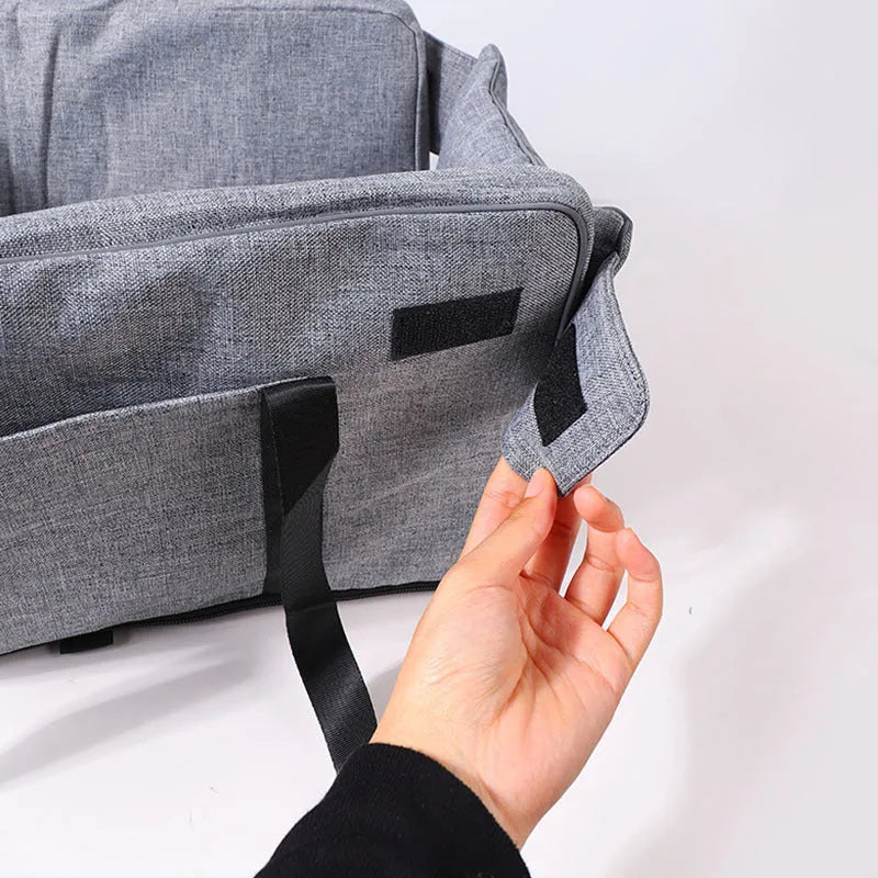 Portable grey cloth dog kennel for outdoor and car travel use.