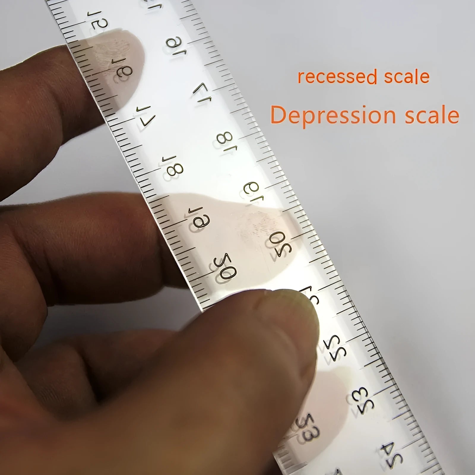 Orange or transparent plastic T-square ruler with dual measurement scales for technical drawing