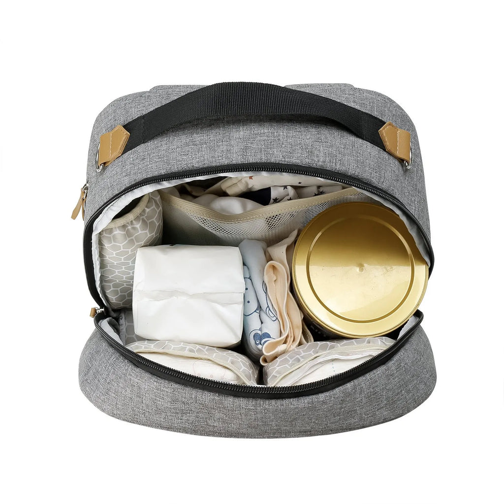 Grey insulated baby carrier backpack with curved shoulder straps and multiple compartments for mother and child travel