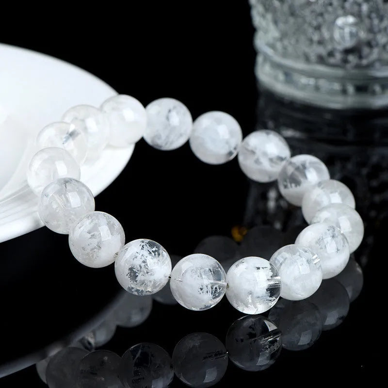 Close-up of a clear crystal blizzard snowflake bead bracelet with Ruyi and Xiangyun design elements.