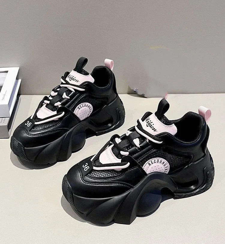 Women's pink casual sneakers with thick sole, cross straps, and mesh lining.