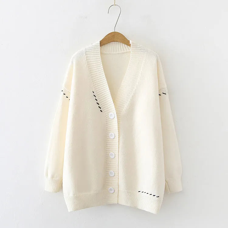 Women's loose-fit knitted cardigan coat in black or white.