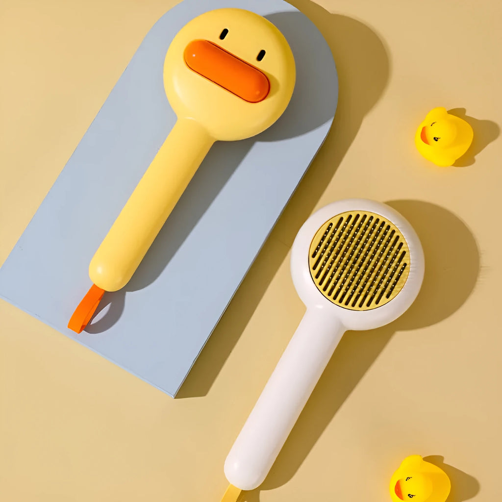 Small yellow duck-shaped pet comb with open needle design for cat and dog grooming