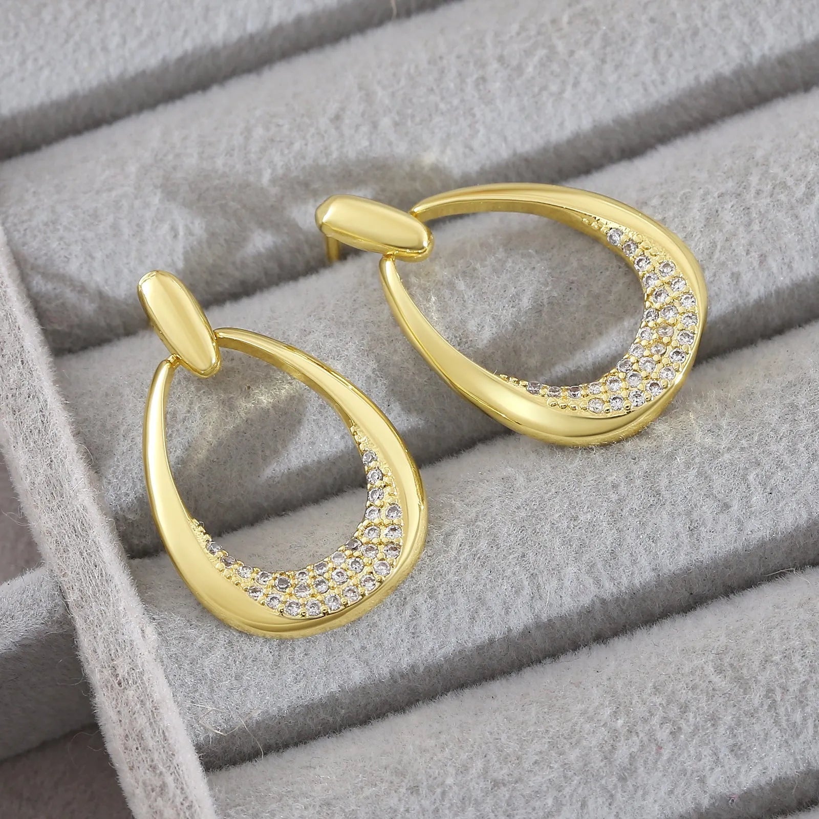 Yellow gold geometric drop earrings for women on a plain background, showing their 2.6 cm length.