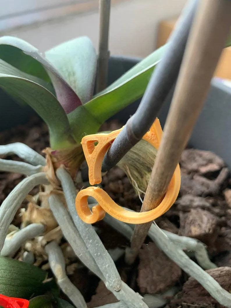 Small cat-shaped plastic clip for gardening in red, yellow, green, and white colours