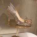 Gold women's pointed toe stiletto heels with rhinestone and sequin decoration on a 7cm heel.