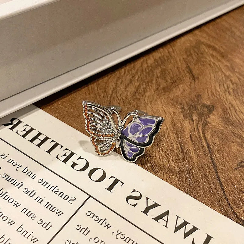 Creative butterfly design women's ring in copper with oil drip finish, showing an open loop style.