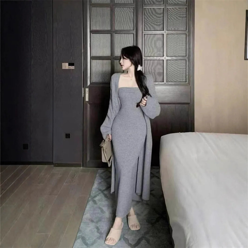 Woman wearing a grey knitted cardigan over a matching long dress with a flocked texture detail.