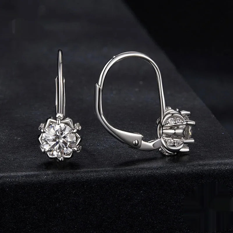 Sterling silver flower bud ear clips with white gold plating and a moissanite centre stone.