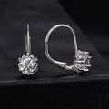 Sterling silver flower bud ear clips with white gold plating and a moissanite centre stone.