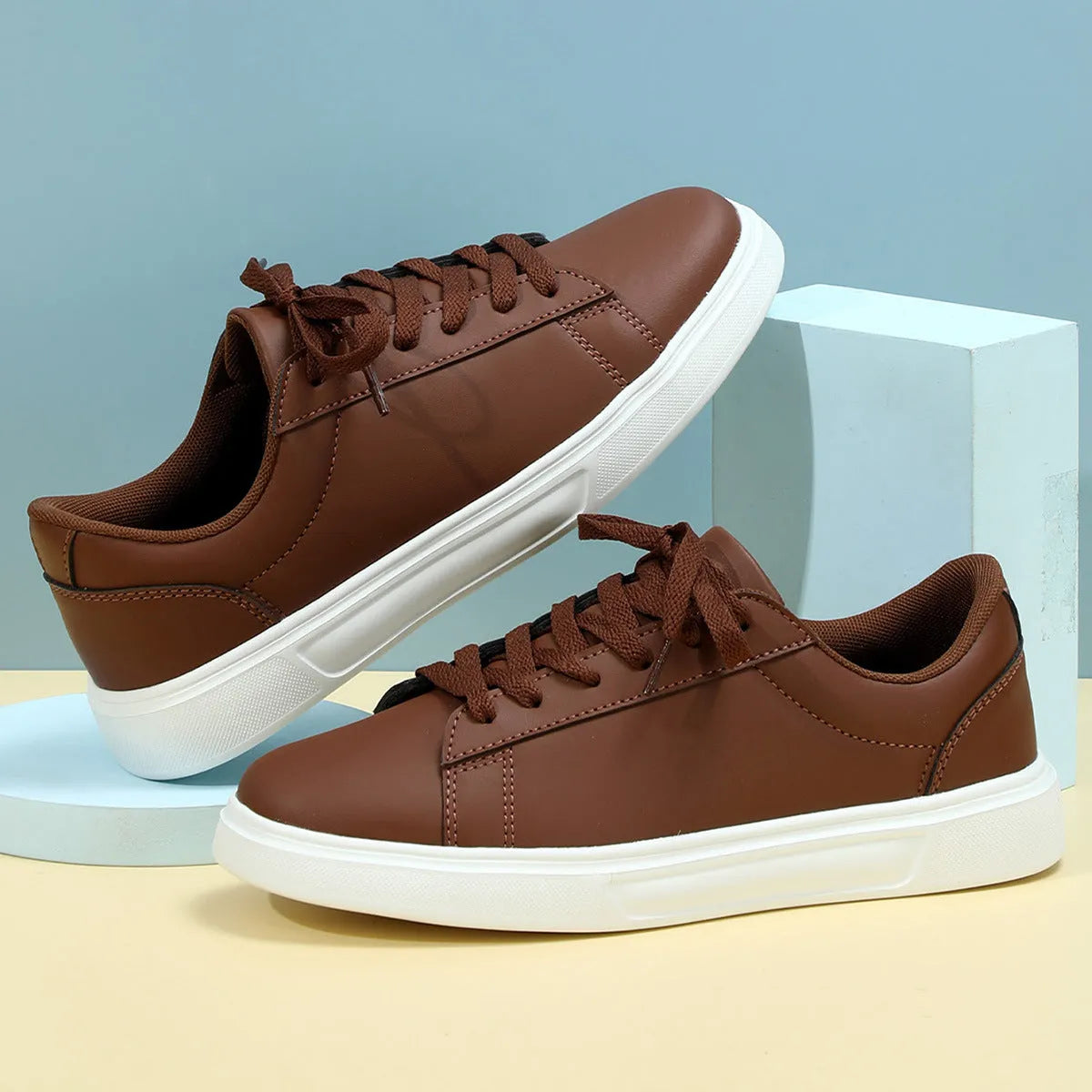 Platform skateboard casual sneaker in beige brown with low top, round toe, and a cross strap detail.