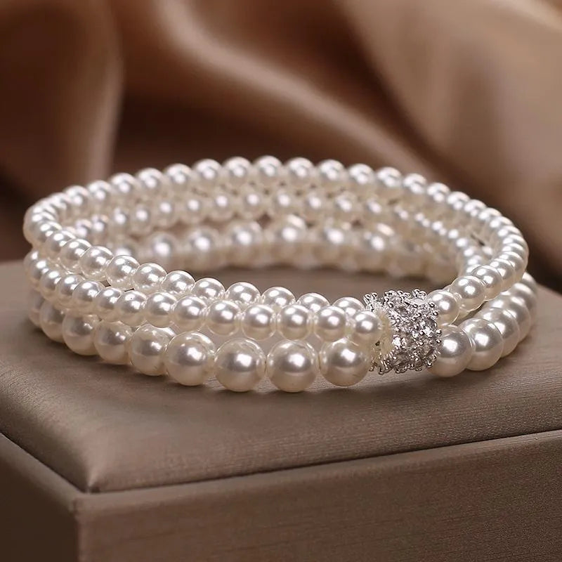 Baroque pearl multi-layer twin bracelet with pink and white imitation pearl beads on display