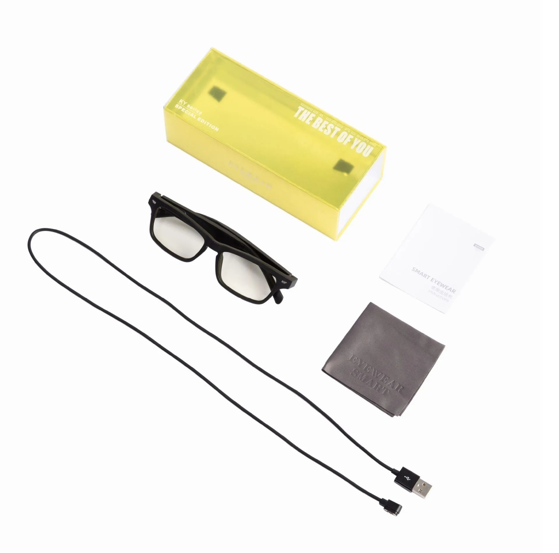 Smart Bluetooth audio glasses with dark lenses on a table, showing temple speakers and a charging case.