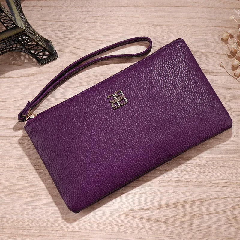 Long slim wine red PU leather wallet handbag with a top zip, shown open to reveal card slots and a phone pocket.