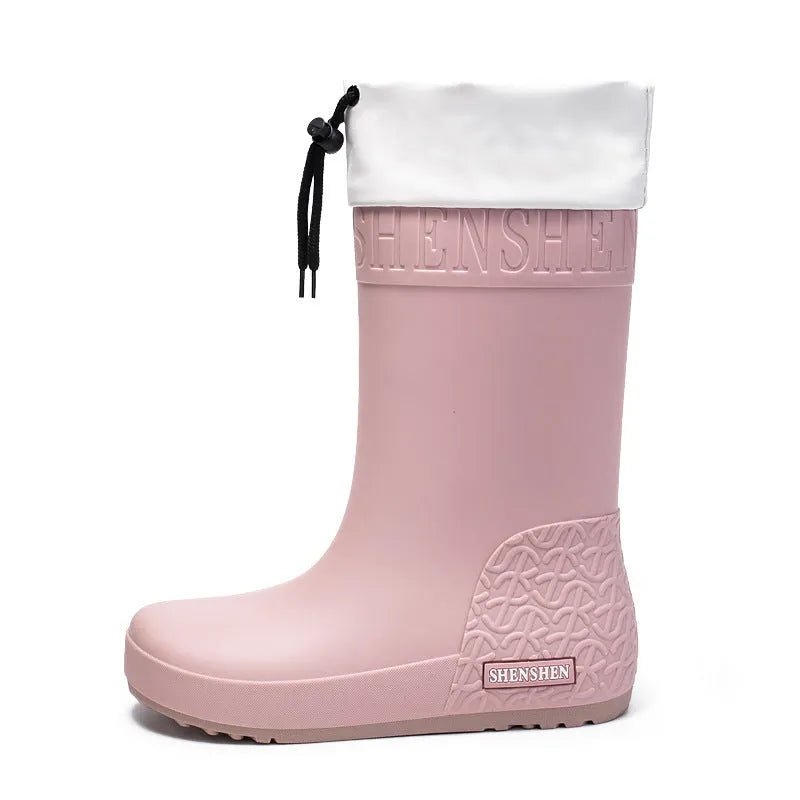 Women's solid colour PVC rain boot with non-slip sole in apricot, black, brown, or pink.